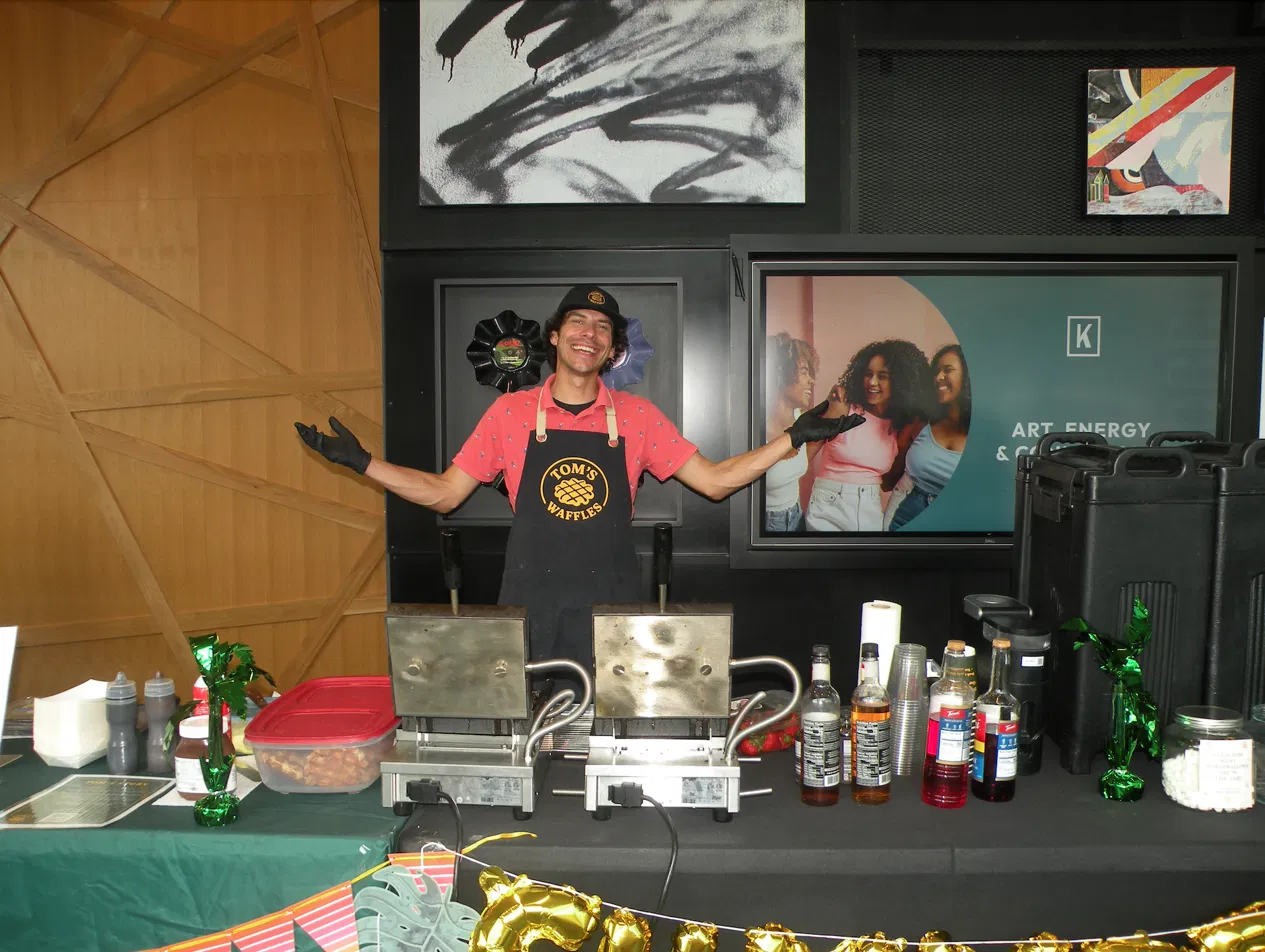 Tom's Waffles indoor setup inside a Denver office building with a fresh waffle station and toppings bar