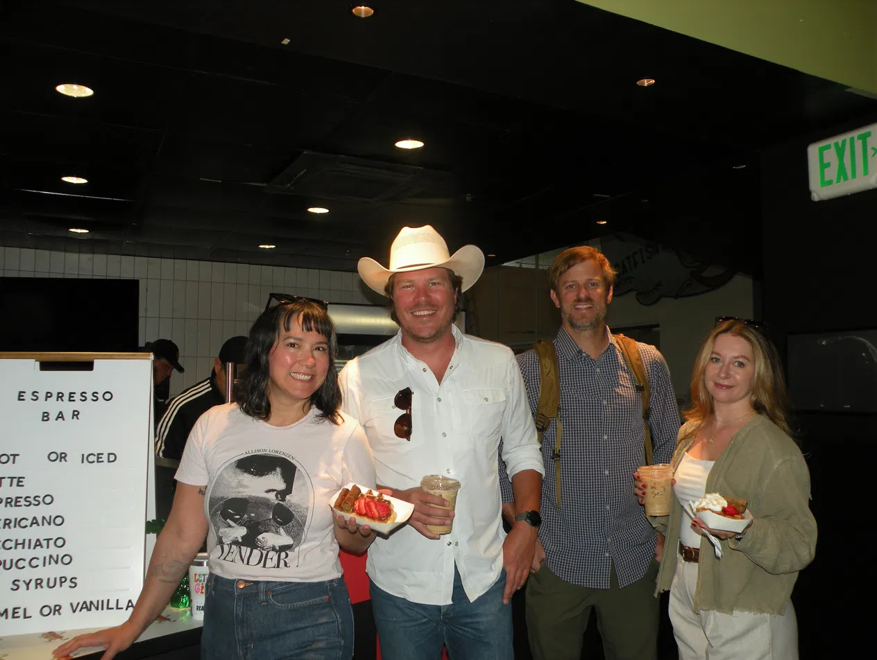 Guests at a Denver corporate event enjoying waffles and espresso drinks from Tom's Waffles catering station