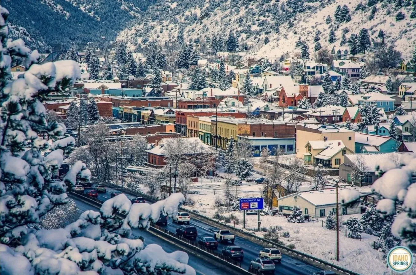 Historic downtown Idaho Springs, Colorado nestled in a snowy Clear Creek canyon along I-70