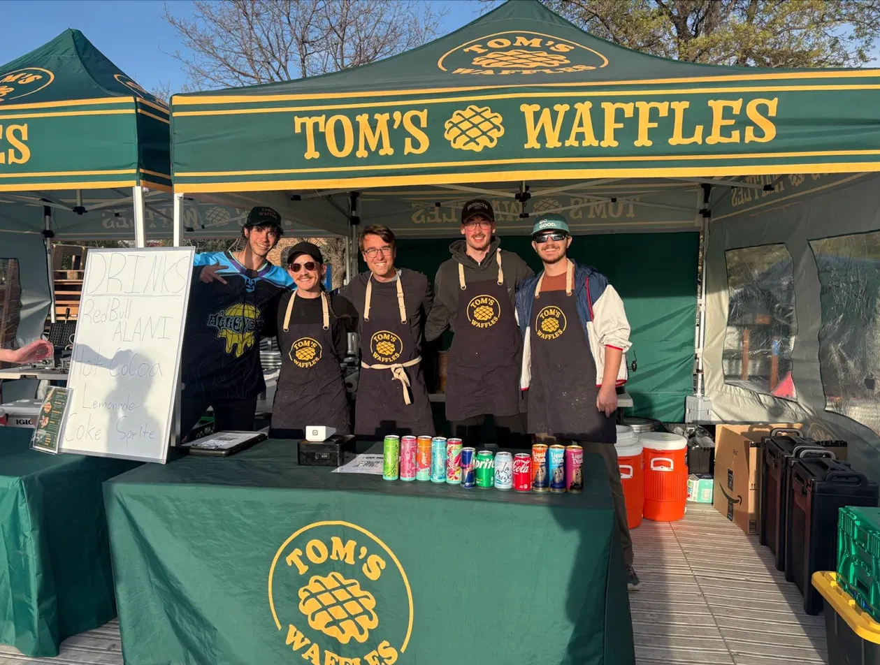 Tom's Waffles crew serving fresh waffles at an Aurora event