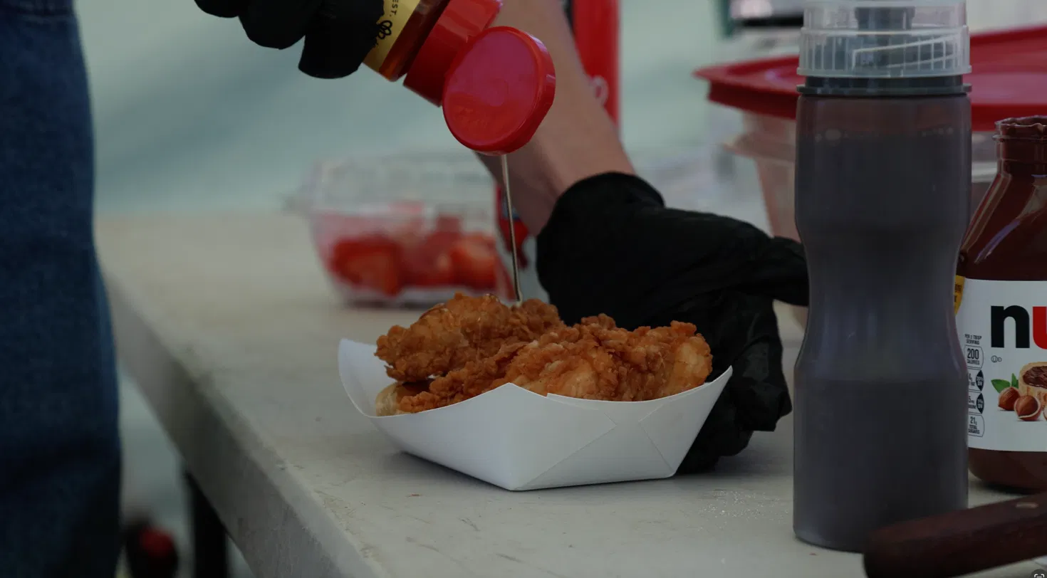 Hot crispy chicken being prepared at a Tom's Waffles catering event