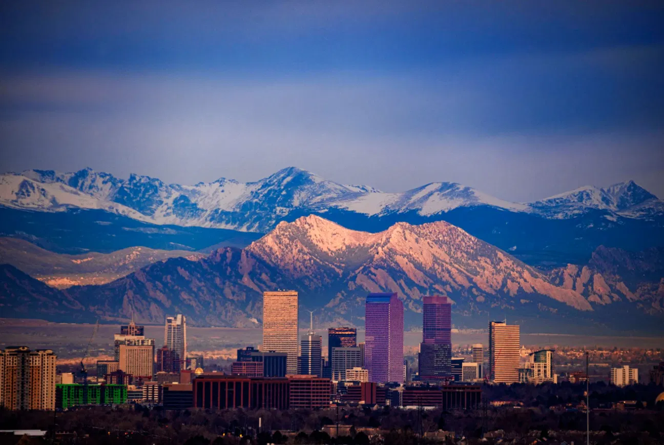 Denver skyline with Rocky Mountains — Tom's Waffles serves waffle catering across Denver CO