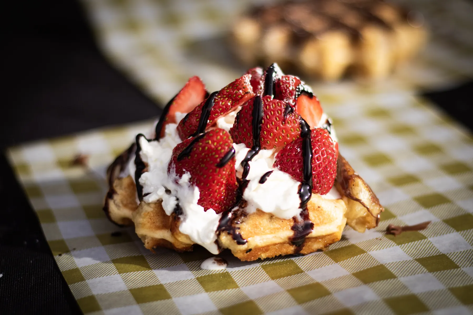 A Liège waffle with strawberries, whipped cream and chocolate