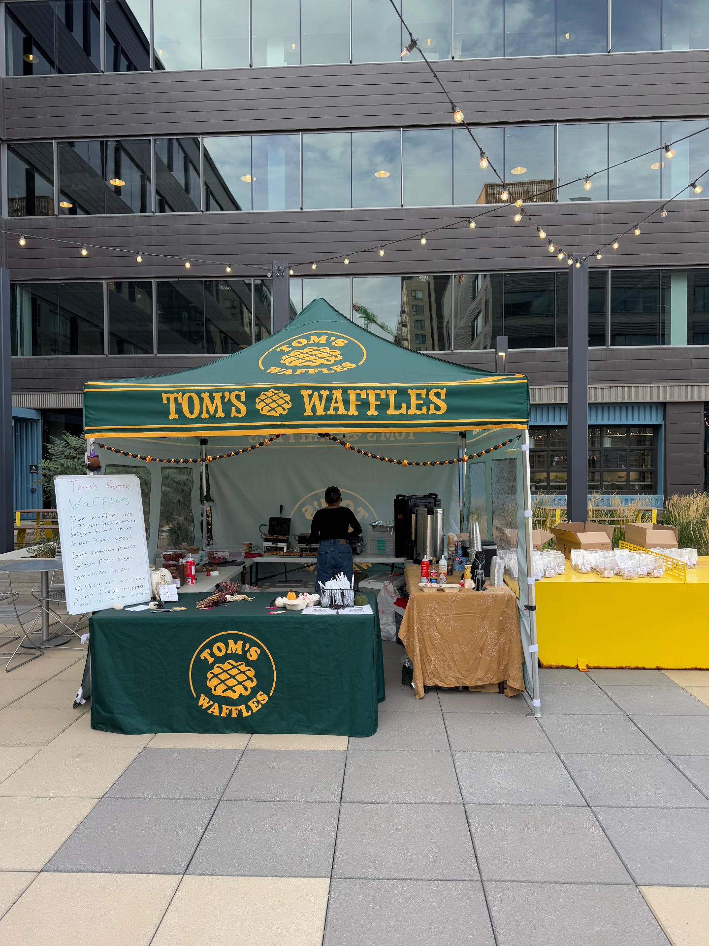 Tom's Waffles branded tent setup at an outdoor corporate event in Denver