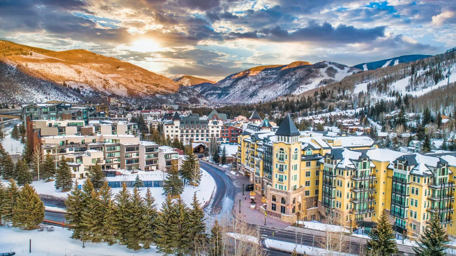 Vail Village at sunset with snow-covered mountains in winter, Colorado