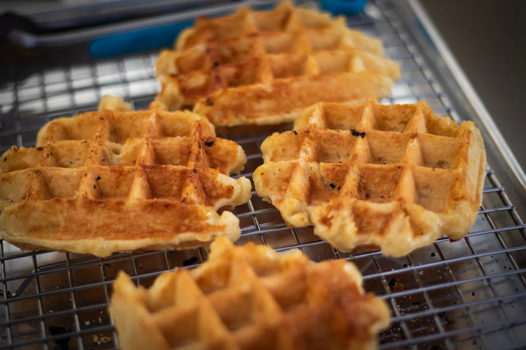 Fresh Liège waffles cooling on a wire rack