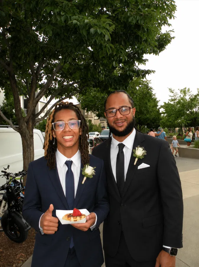 Guests in formal attire enjoying fresh Belgian waffles at a Tom's Waffles wedding event in Denver